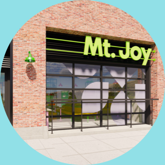 Mt joy is a restaurant in a brick building with a green sign.