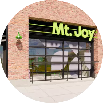 Mt joy is a restaurant in a brick building with a green sign.